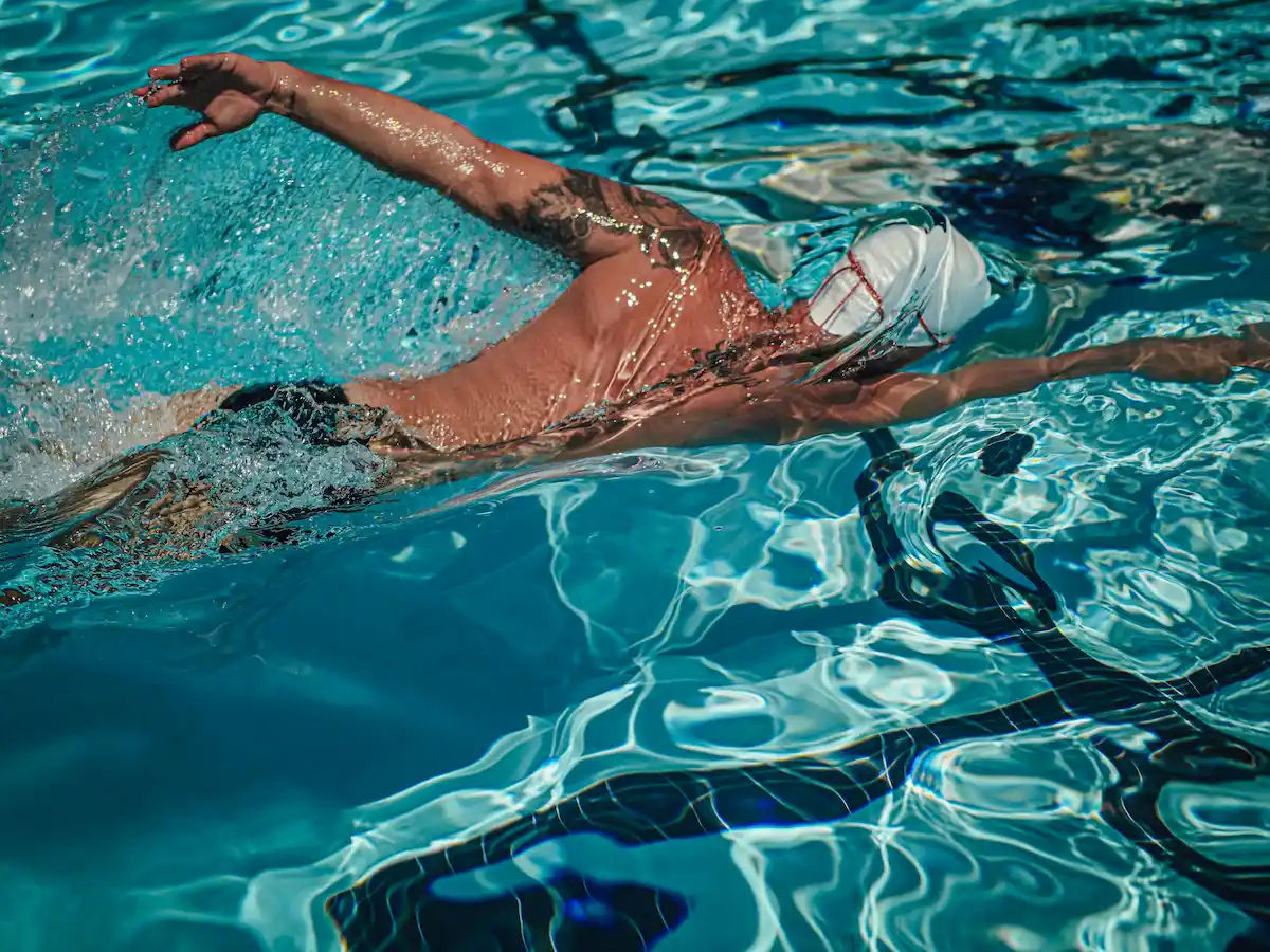 Adult swimmer training in pool lane